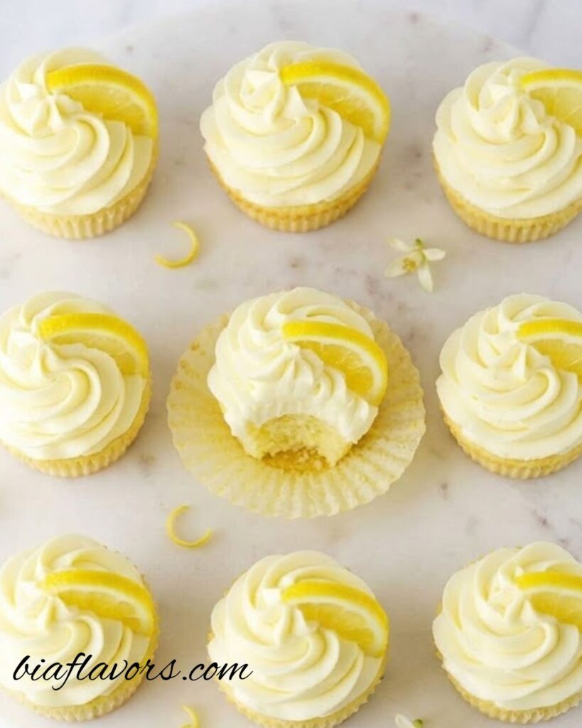 Freshly baked lemon cupcakes with a light golden top and fluffy texture