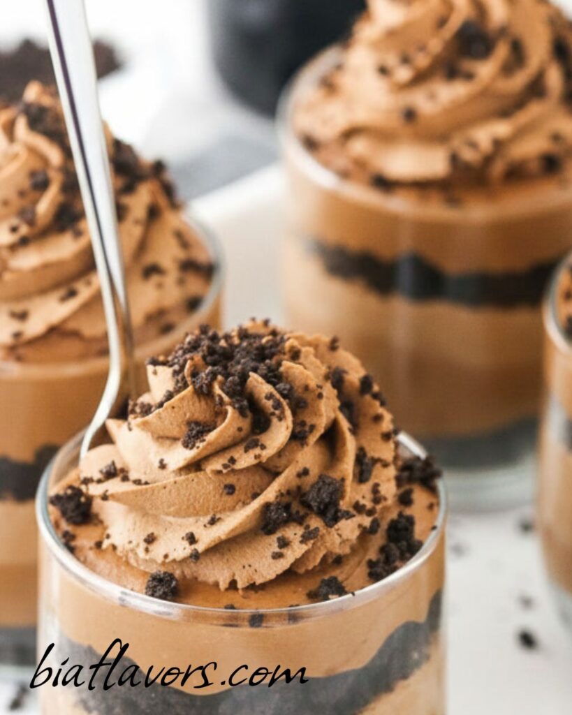 Mini chocolate cheesecake dessert cups with Baileys and whipped cream