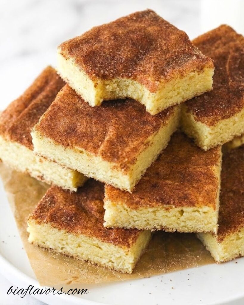 Soft and chewy snickerdoodle cookie bars topped with cinnamon sugar, baked in a square pan