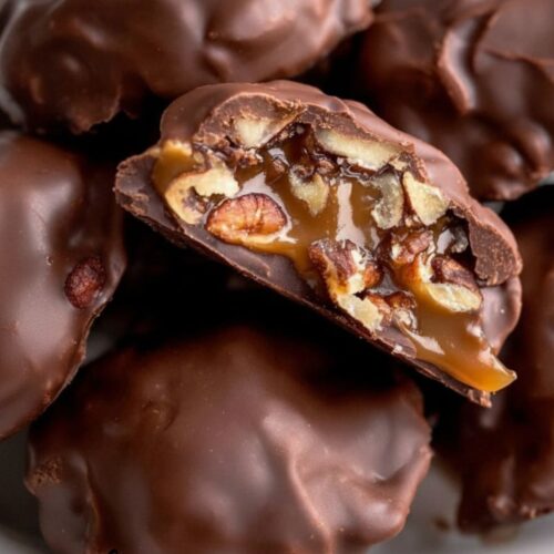 Homemade chocolate turtles with pecans, gooey caramel, and smooth chocolate coating