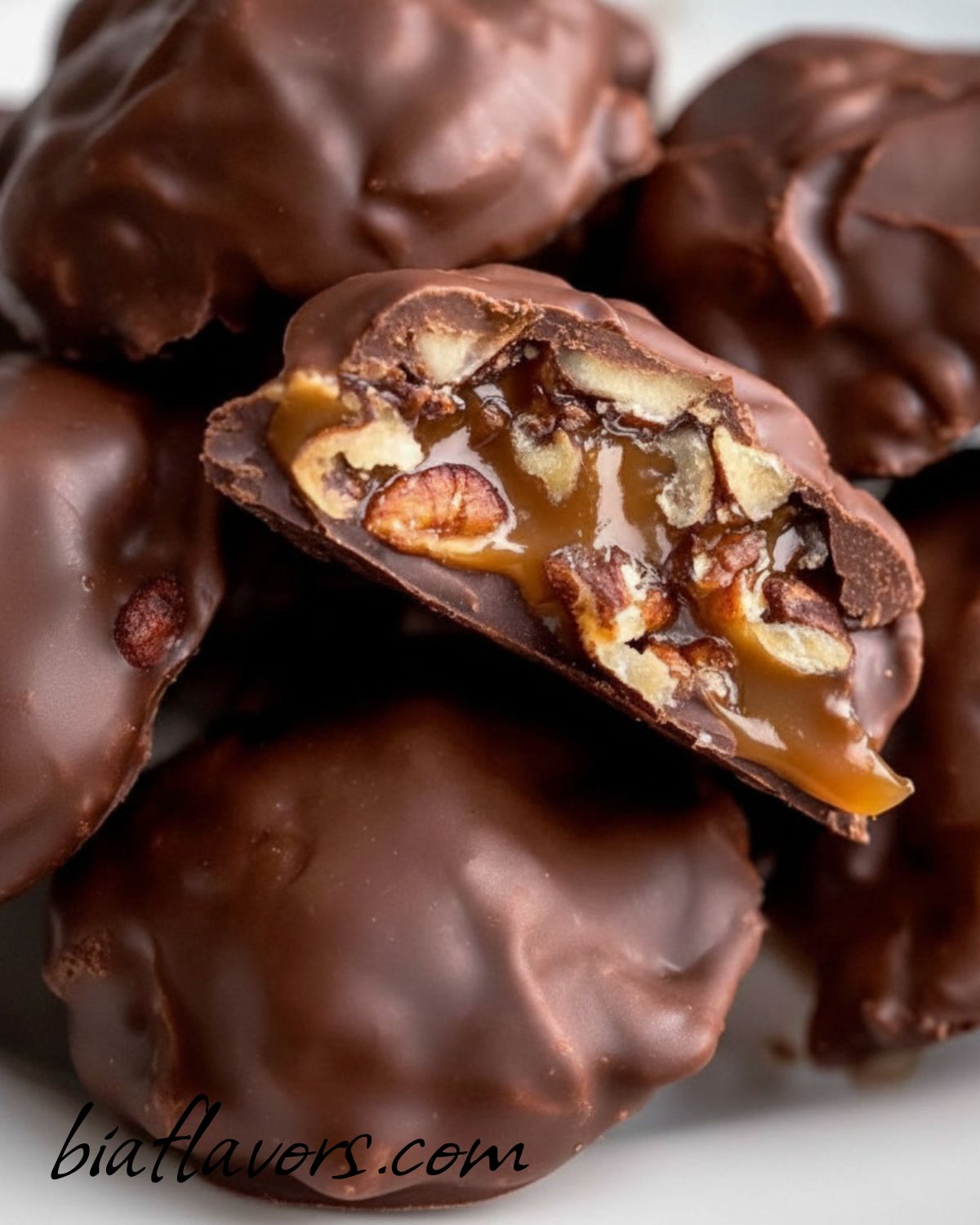 Homemade chocolate turtles with pecans, gooey caramel, and smooth chocolate coating