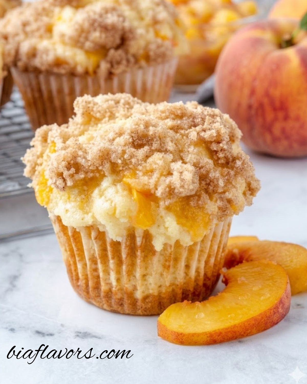 Homemade peach cobbler muffins served warm with a crispy streusel topping