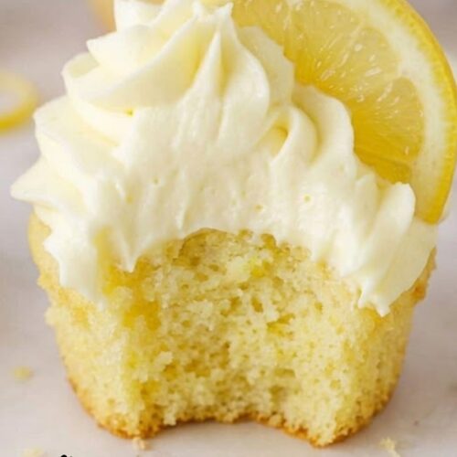 Soft and moist lemon cupcakes with lemon buttercream frosting on a white plate