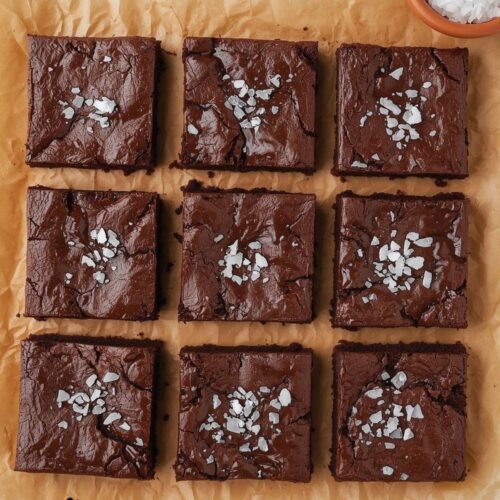 Fudgy malted brownies cut into squares with rich chocolate texture