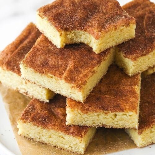 Soft and chewy snickerdoodle cookie bars topped with cinnamon sugar, baked in a square pan
