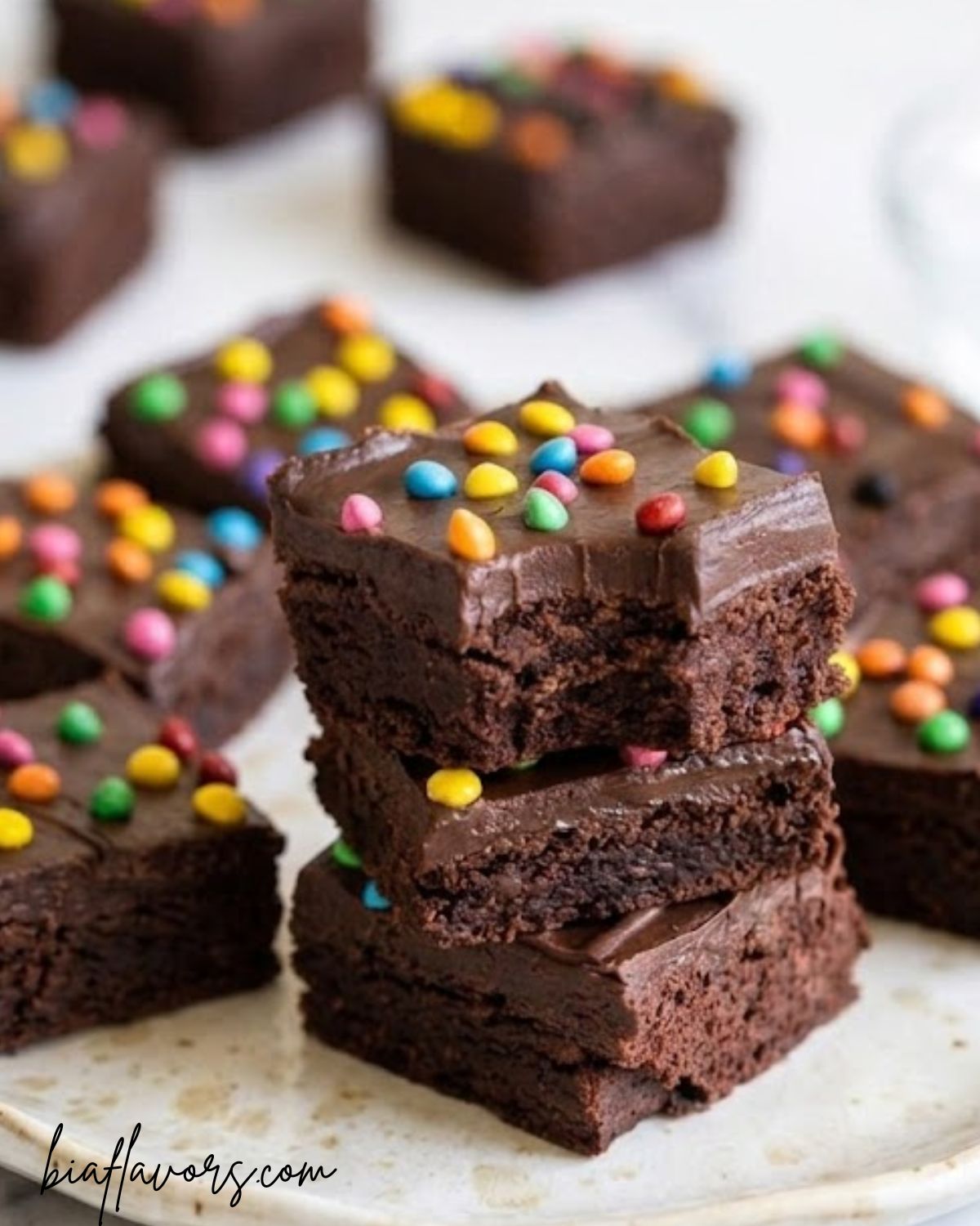 fudgy cosmic brownies with chocolate frosting and colorful candy topping