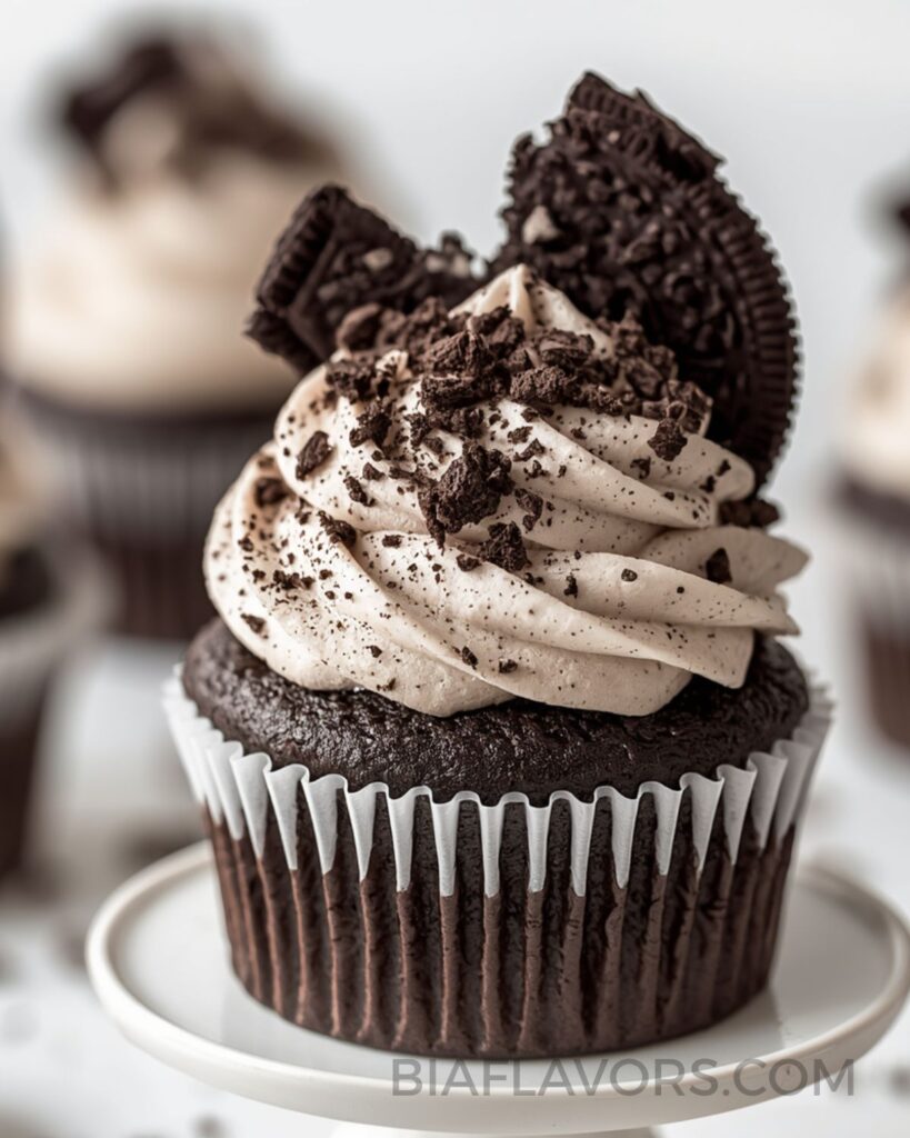 Oreo cupcakes topped with creamy cookies and cream frosting and crushed Oreo biscuits