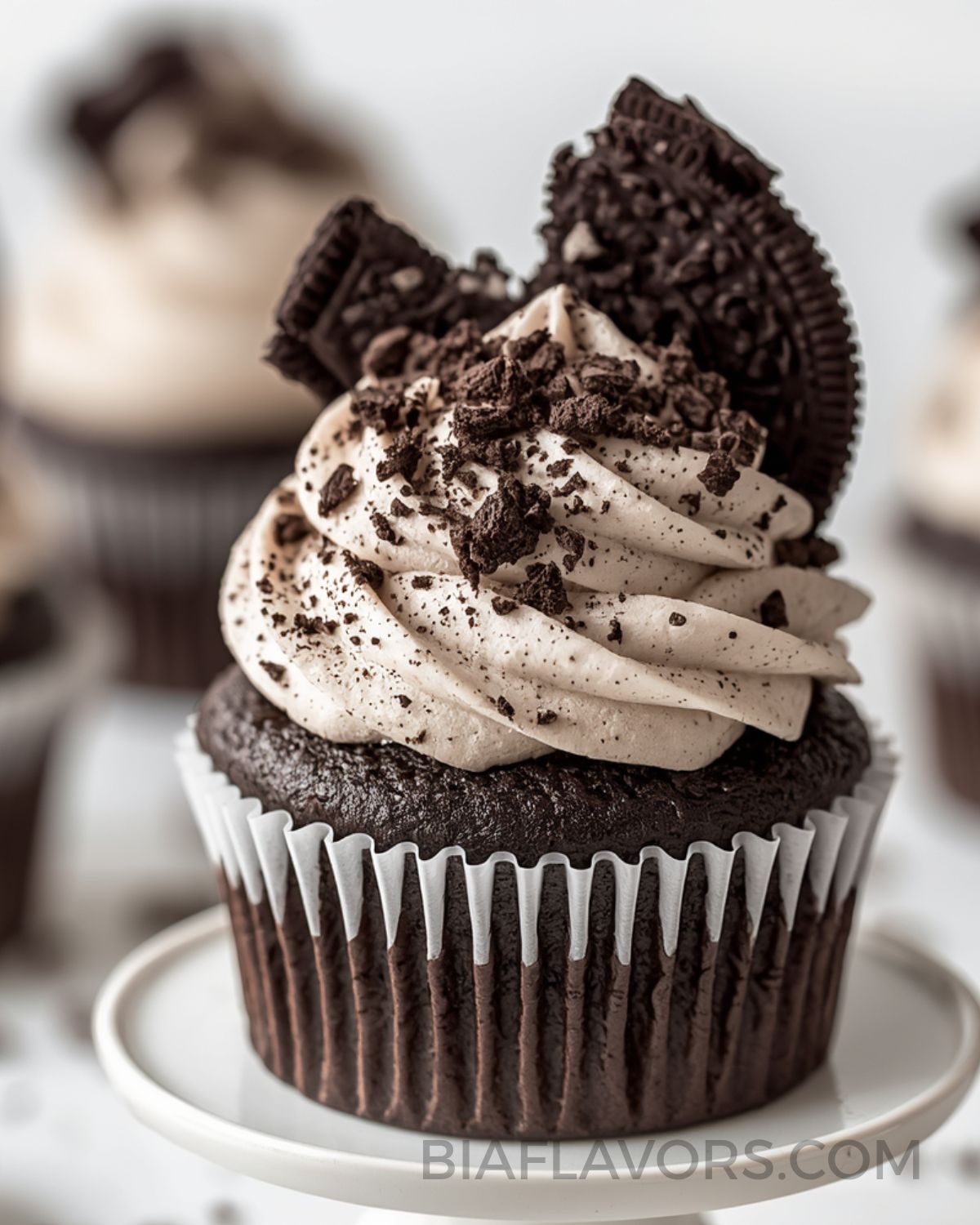 Oreo cupcakes topped with creamy cookies and cream frosting and crushed Oreo biscuits